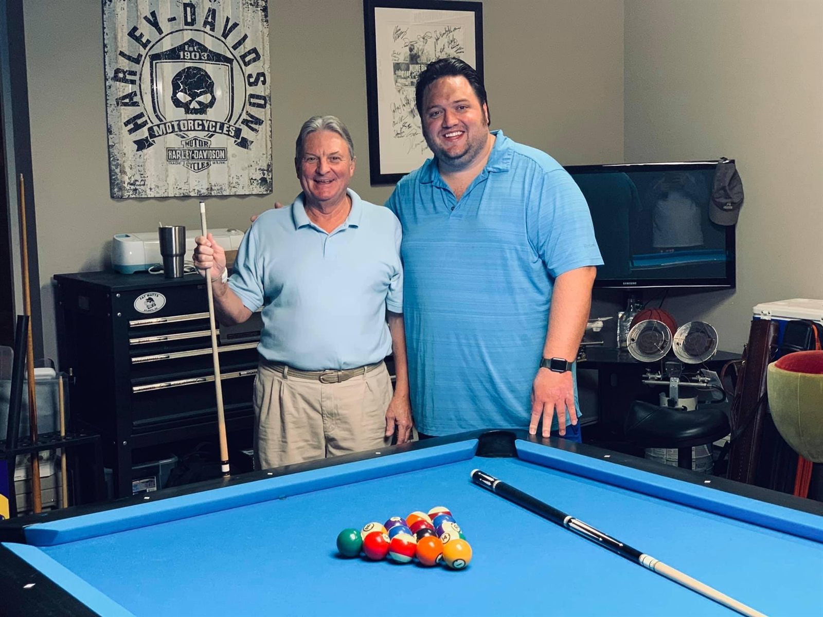 Bill McDaniel and Chase Channell standing at the rack end of a pool table